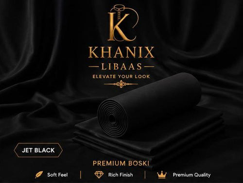 A rolled and folded piece of Khanix Libaas premium boski fabric in jet black, set against a draped black satin background with gold branding and text overlays.